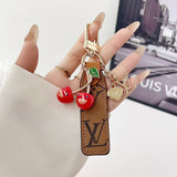 louis vuitton Cherry Charm Keychain with Monogram Leather Strap Luxury Designer Bag and Key Accessory